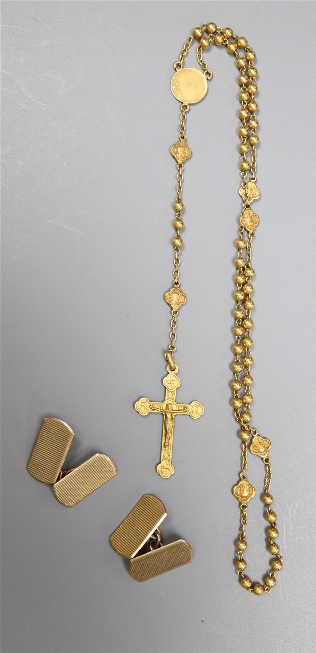 A pair of engine-turned 9ct gold oval cufflinks and a yellow metal rosary (tests as 18ct) in a small leather case
